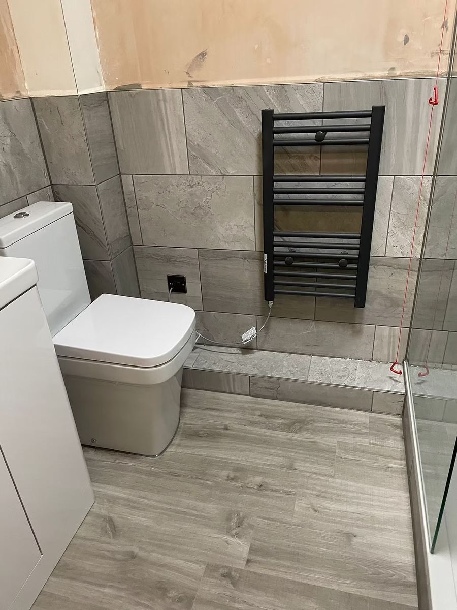 Bathroom installation with heated towel rail